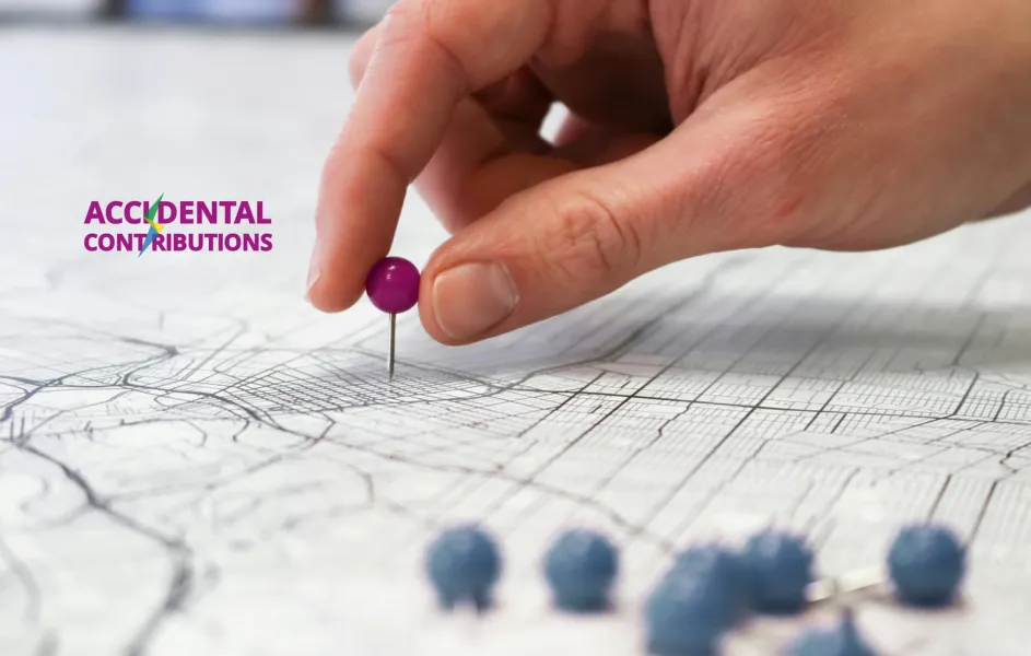 A hand is sticking a pin into a stylized city map. Mounted project logo: Accidental Contributions